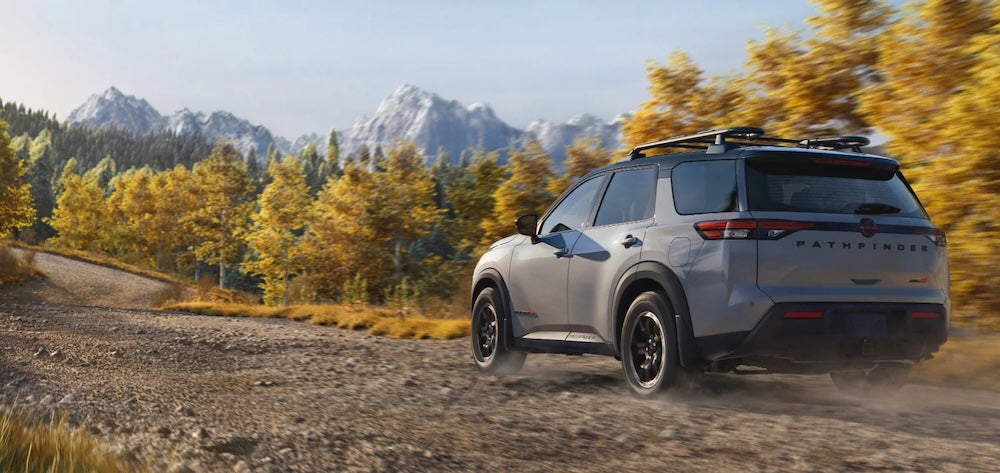 A gray 2026 Nissan Pathfinder SUV driving up a rocky mountain path