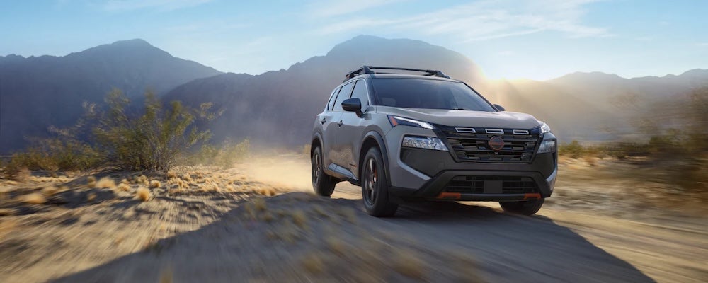 A gray 2026 Nissan Rogue SUV driving through the desert